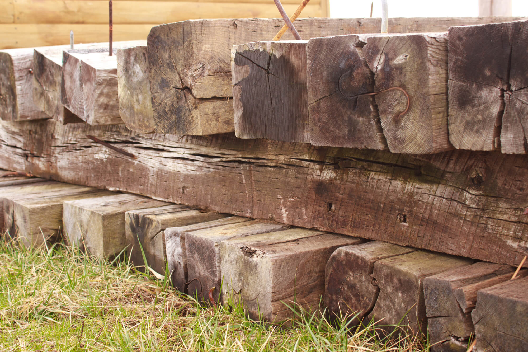 railroad ties stacked on grass